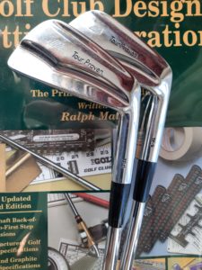 Image of golf clubs and golf club fitting manual.
